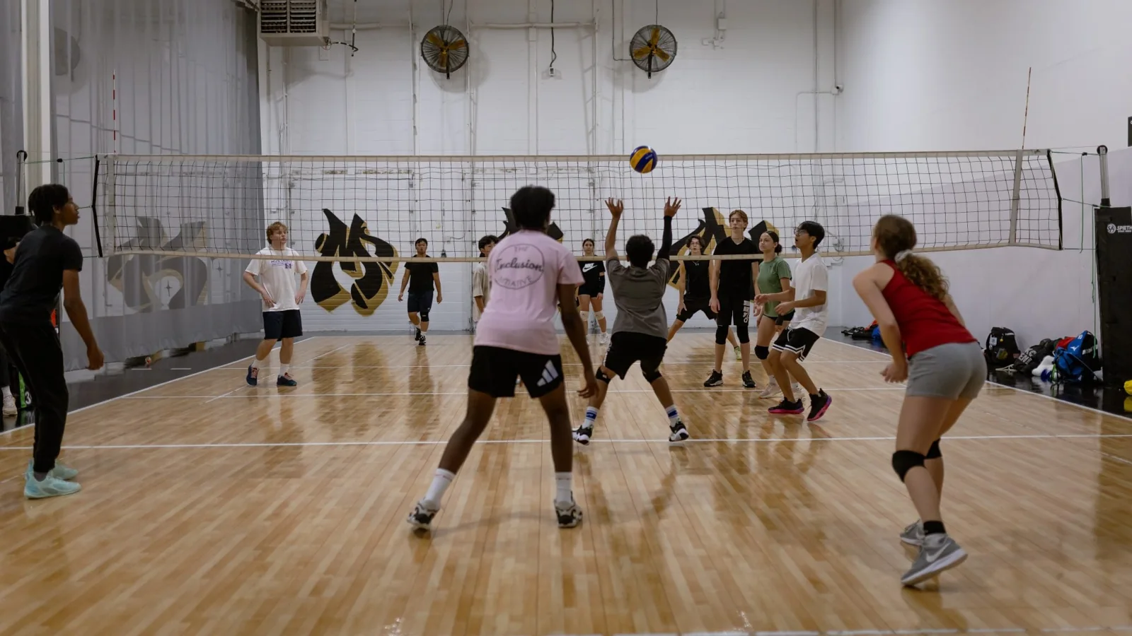 Players taking part in indoor volleyball