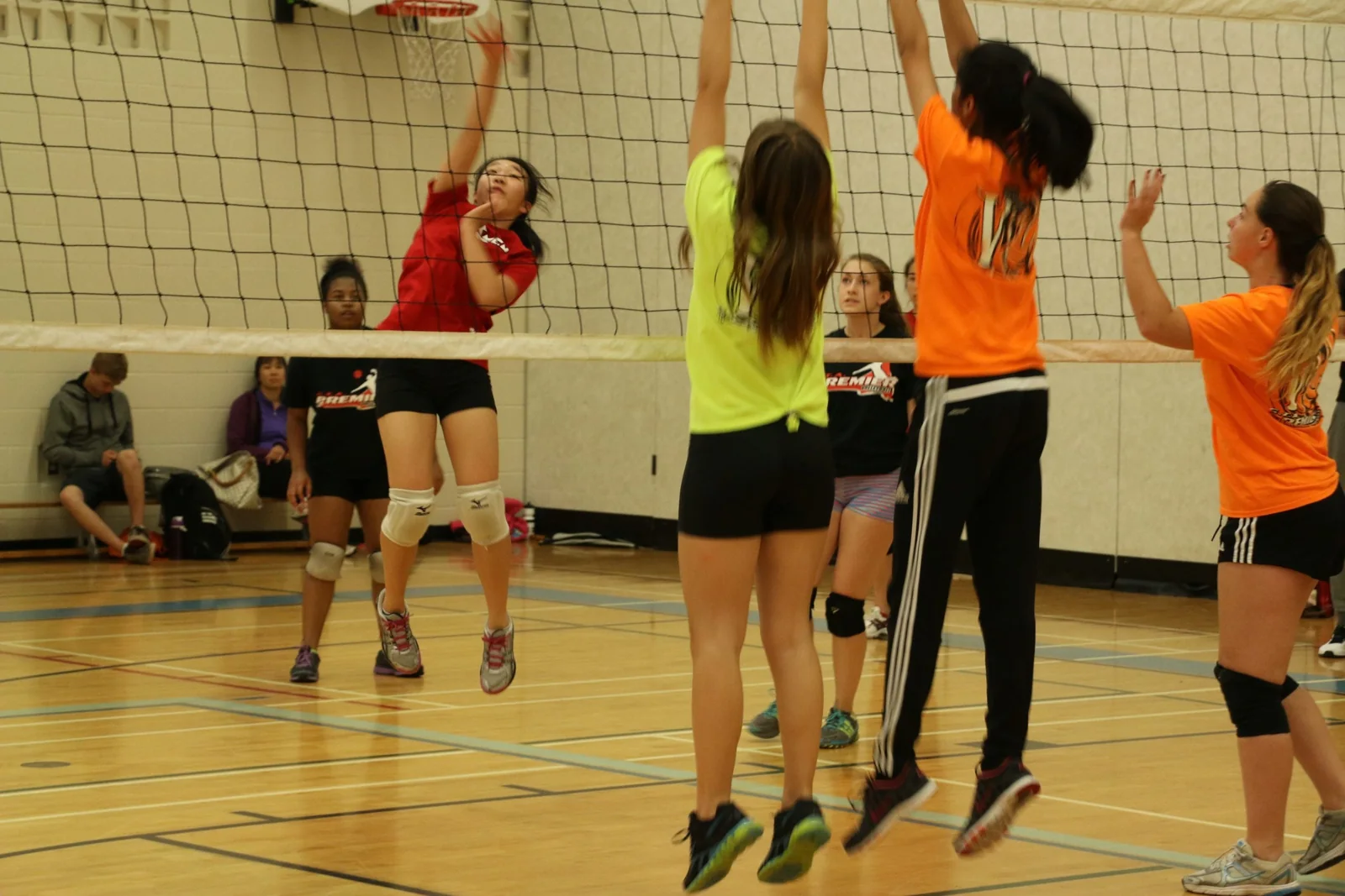 Youth players practising volleyball together